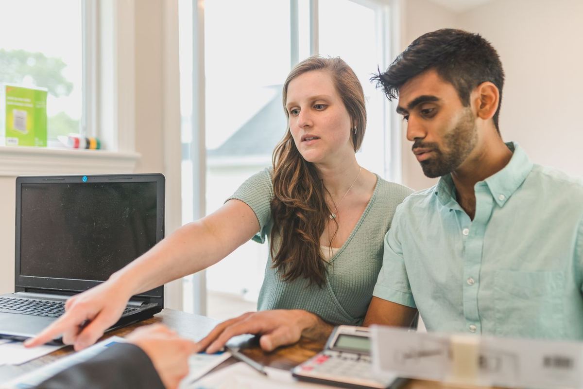 Debt Negotiation Services — couple reviewing loan documents