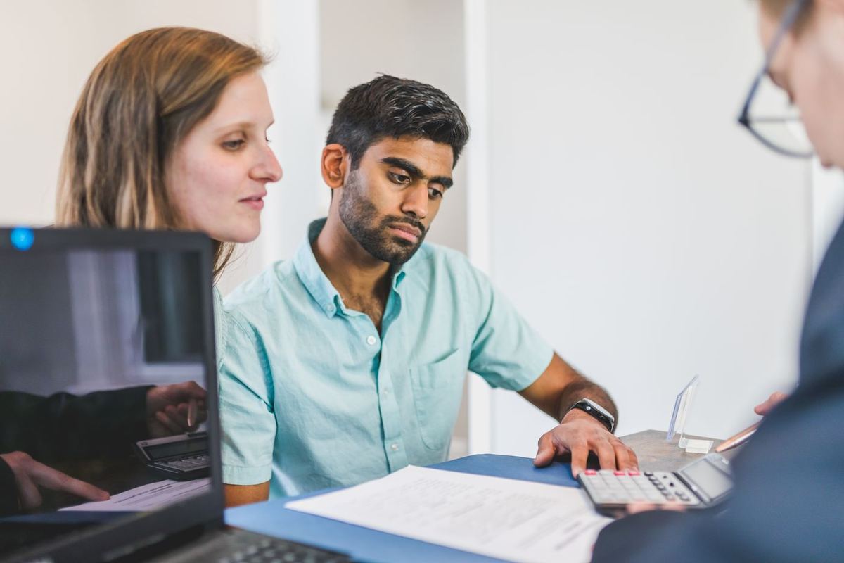 Debt consolidation loans in Wheeling, WV — couple meeting with a lender