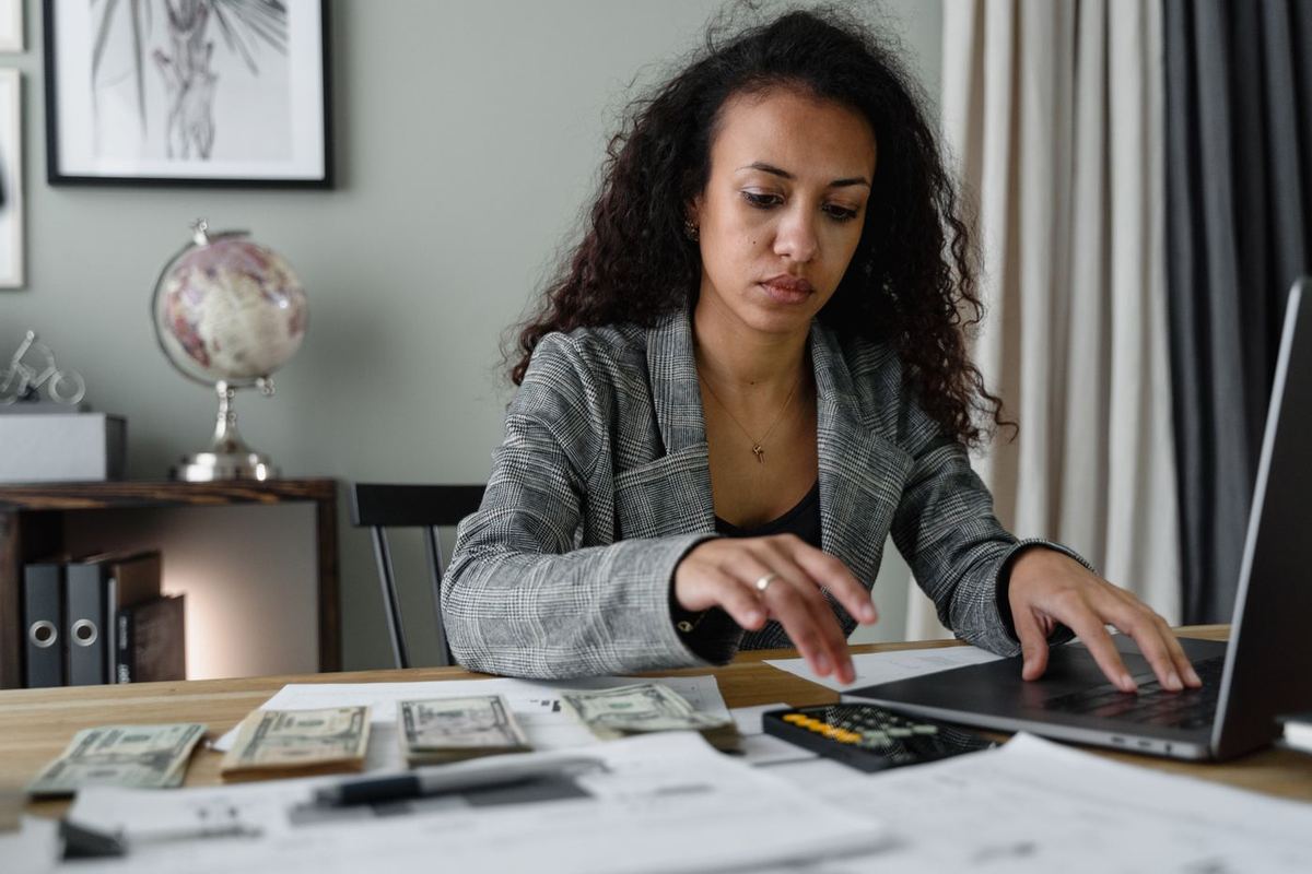How to Avoid Bankruptcy — woman sorting through financial documents