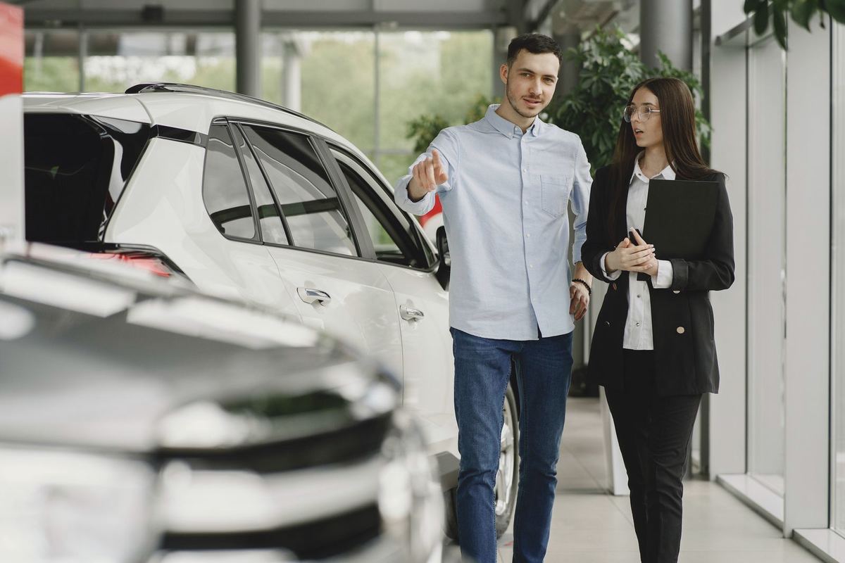 Debt Relief Instead of Bankruptcy — car buyer walking a dealership floor with a sales consultant