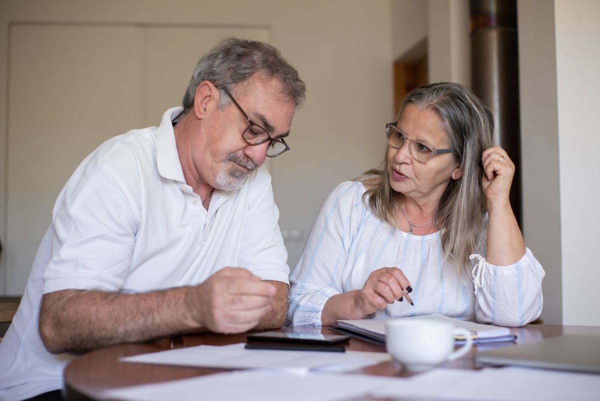 Payday loans in West Virginia — older couple organizing paperwork and payments