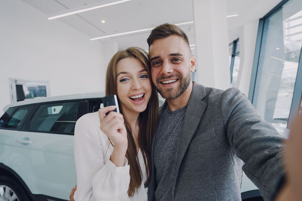 Debt consolidation loans in Morgantown, WV — couple celebrating a new car purchase