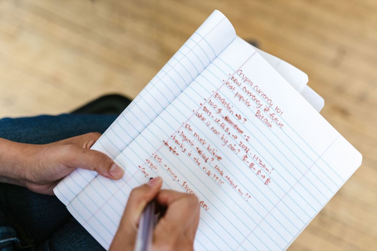 Debt Negotiation Services — writing notes in a notebook