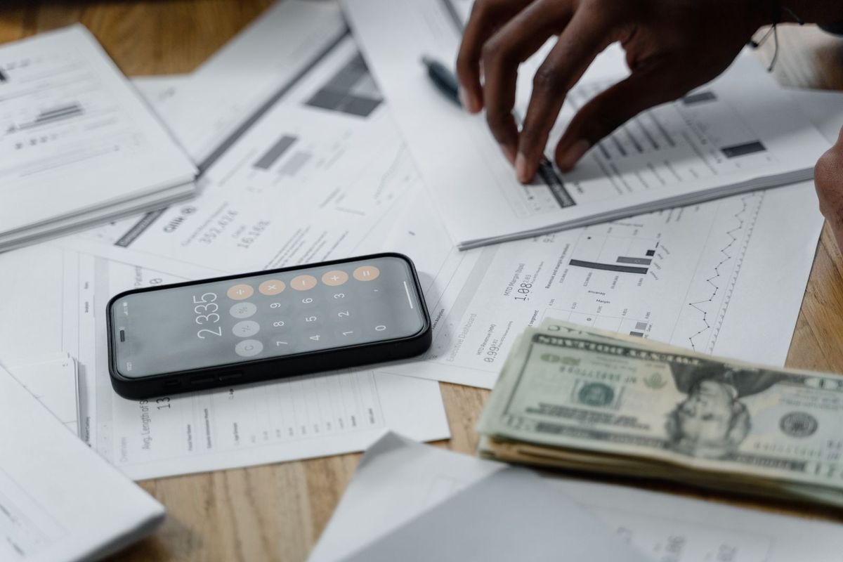 Credit Card Debt Relief — calculator and bills on papers