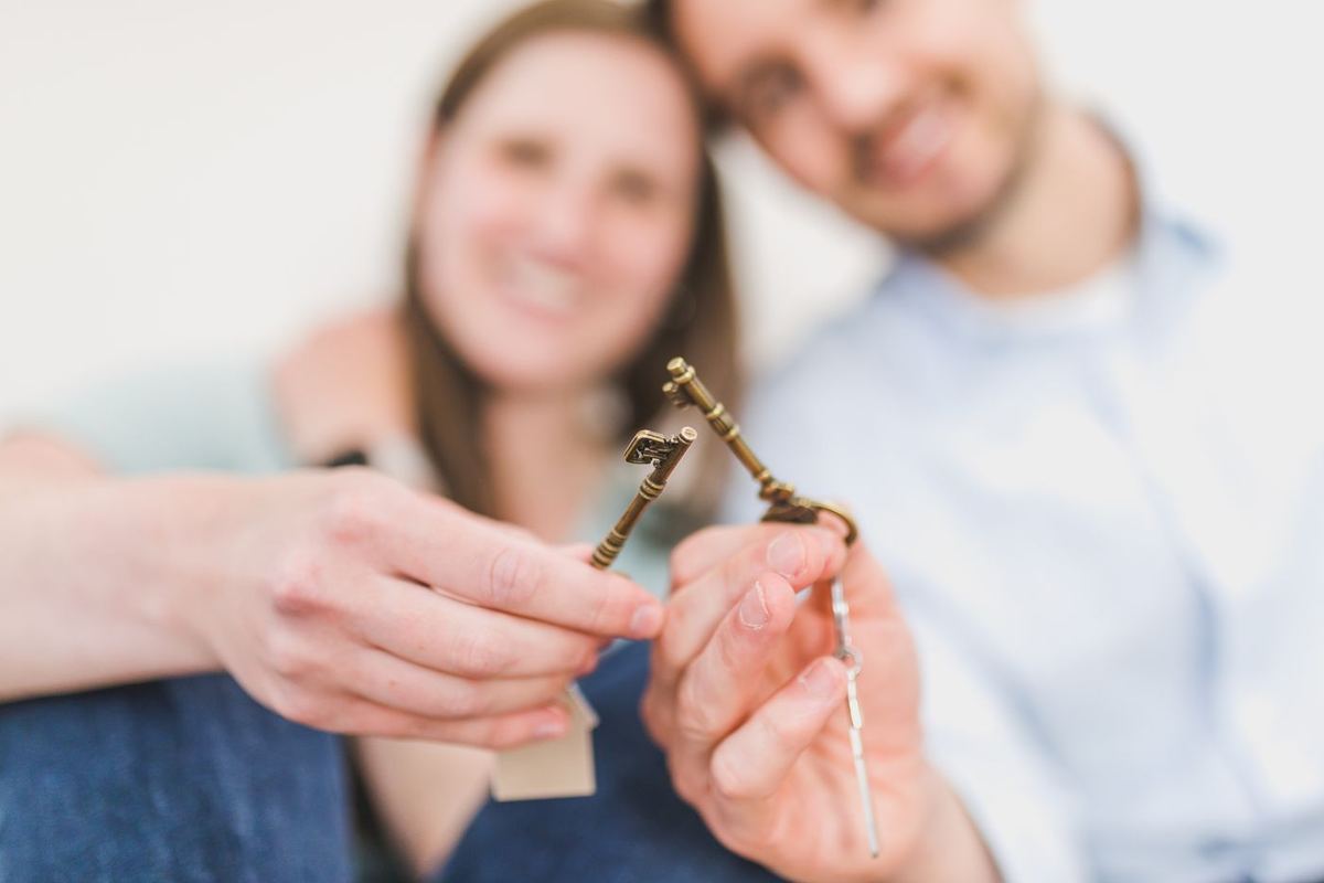 Debt Settlement Programs — couple celebrating a new home