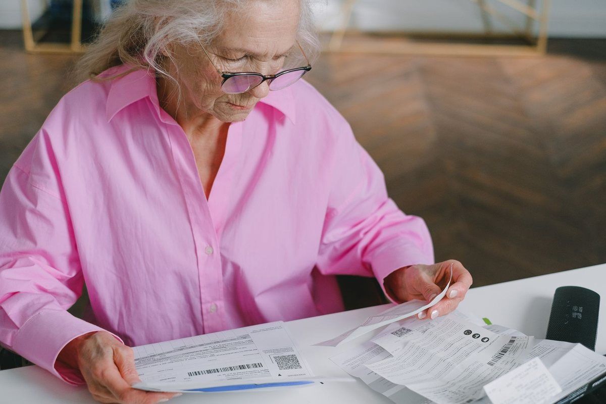 Debt consolidation loans in Morgantown, WV — older woman reviewing bills