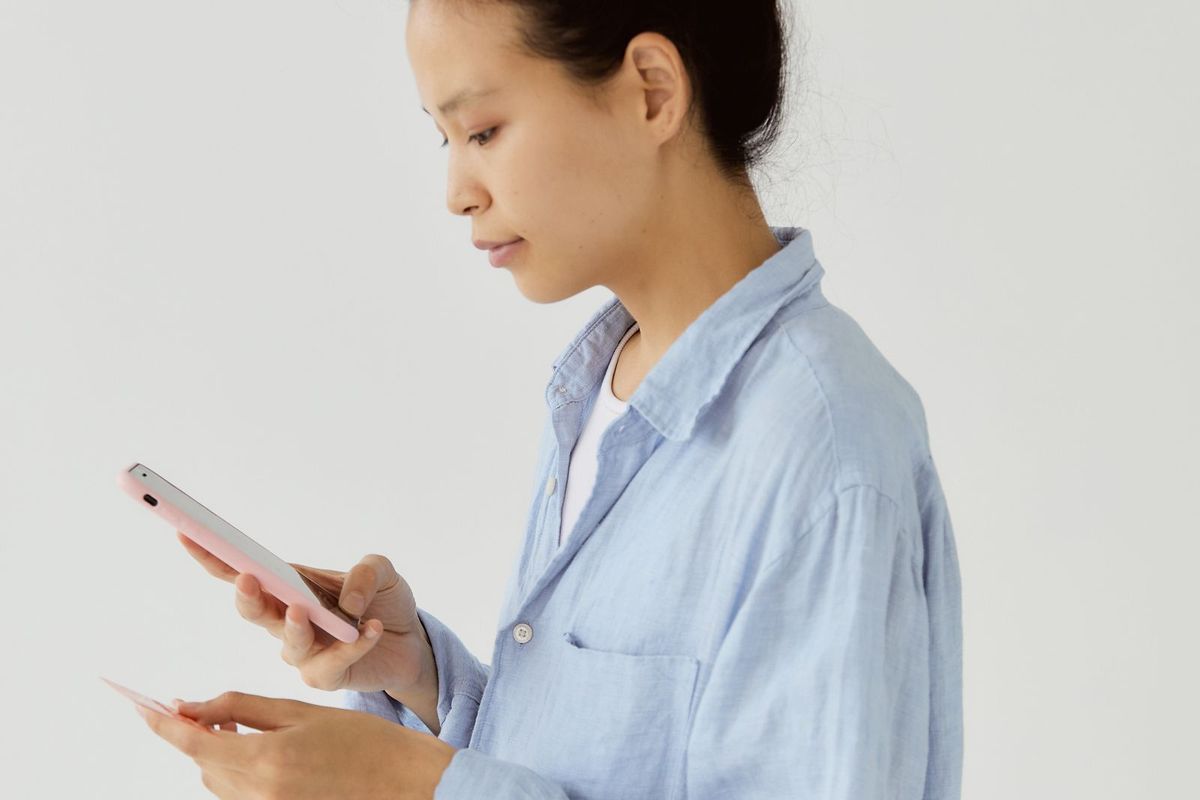 Payday loans in West Virginia — woman checking her account on a phone