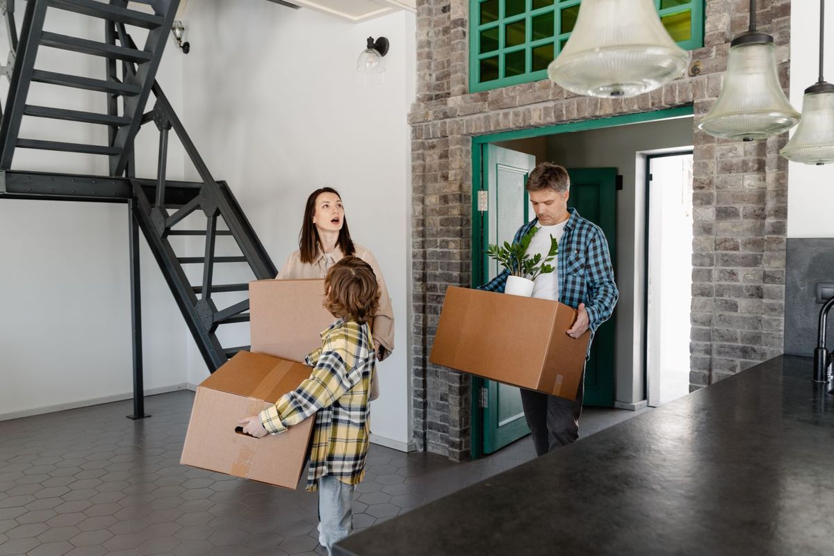 Payday Loan Consolidation in Charleston, WV — family carrying boxes into their new home