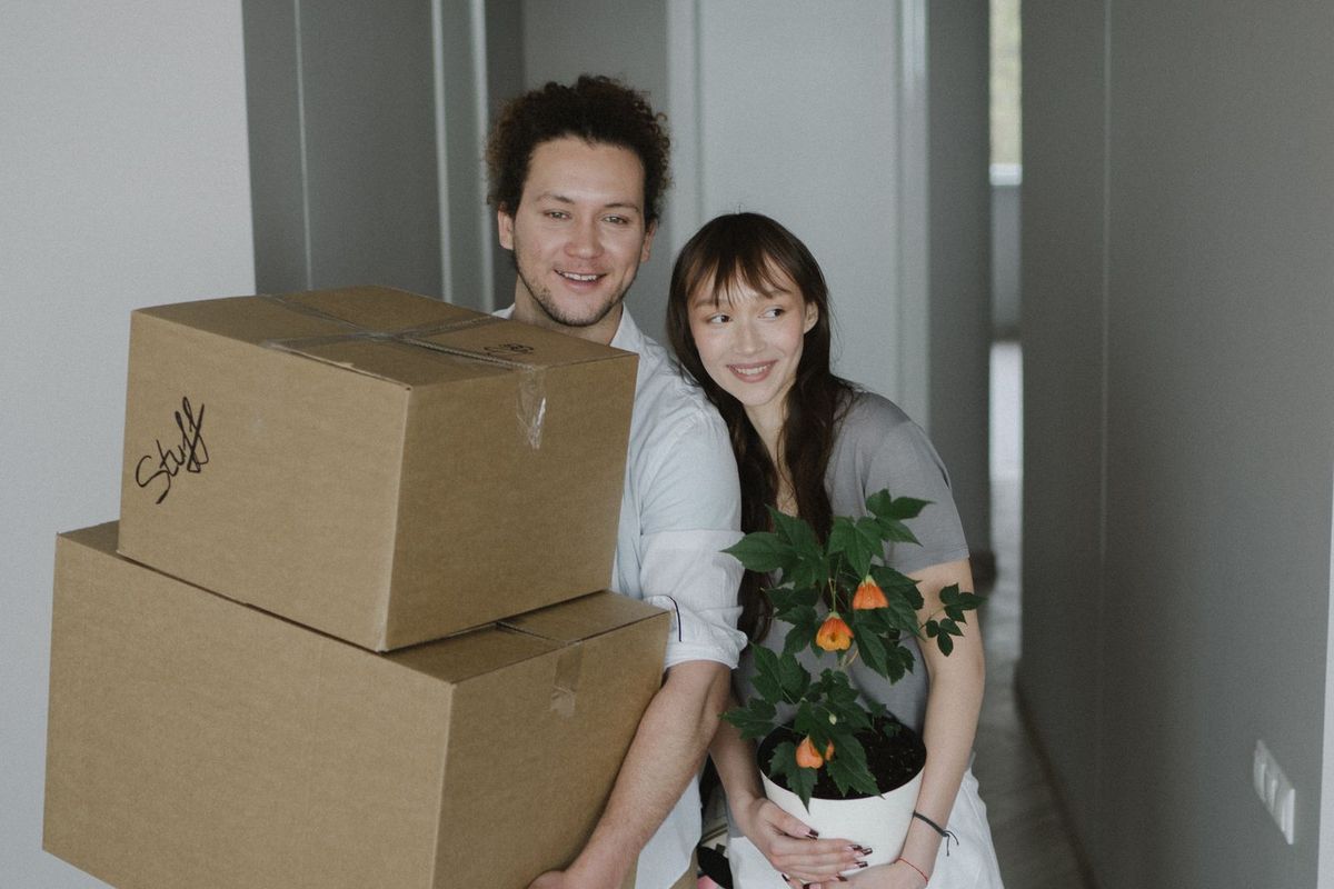 Debt consolidation loans in Charleston, WV — couple moving boxes into a new place