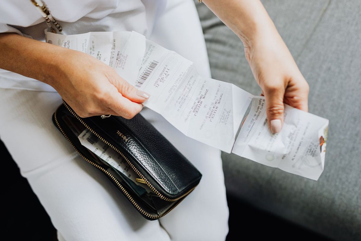 Payday Loan Relief in Charleston, WV — sorting receipts from a wallet