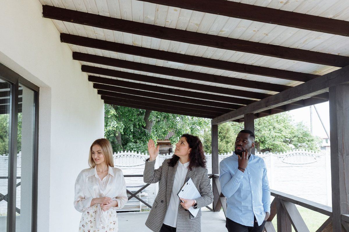 Credit Card Debt Relief — buyers with an agent on a porch