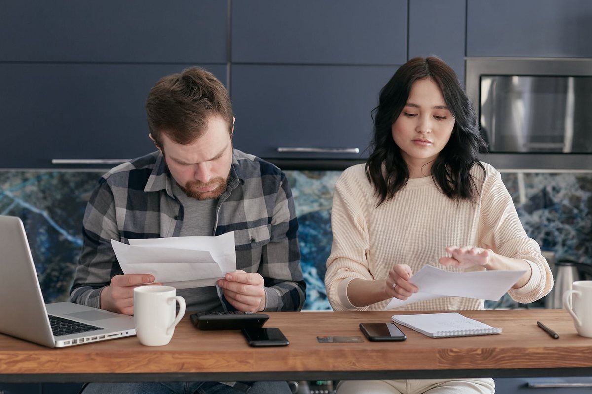 Debt consolidation loans in Parkersburg, WV — couple looking at documents