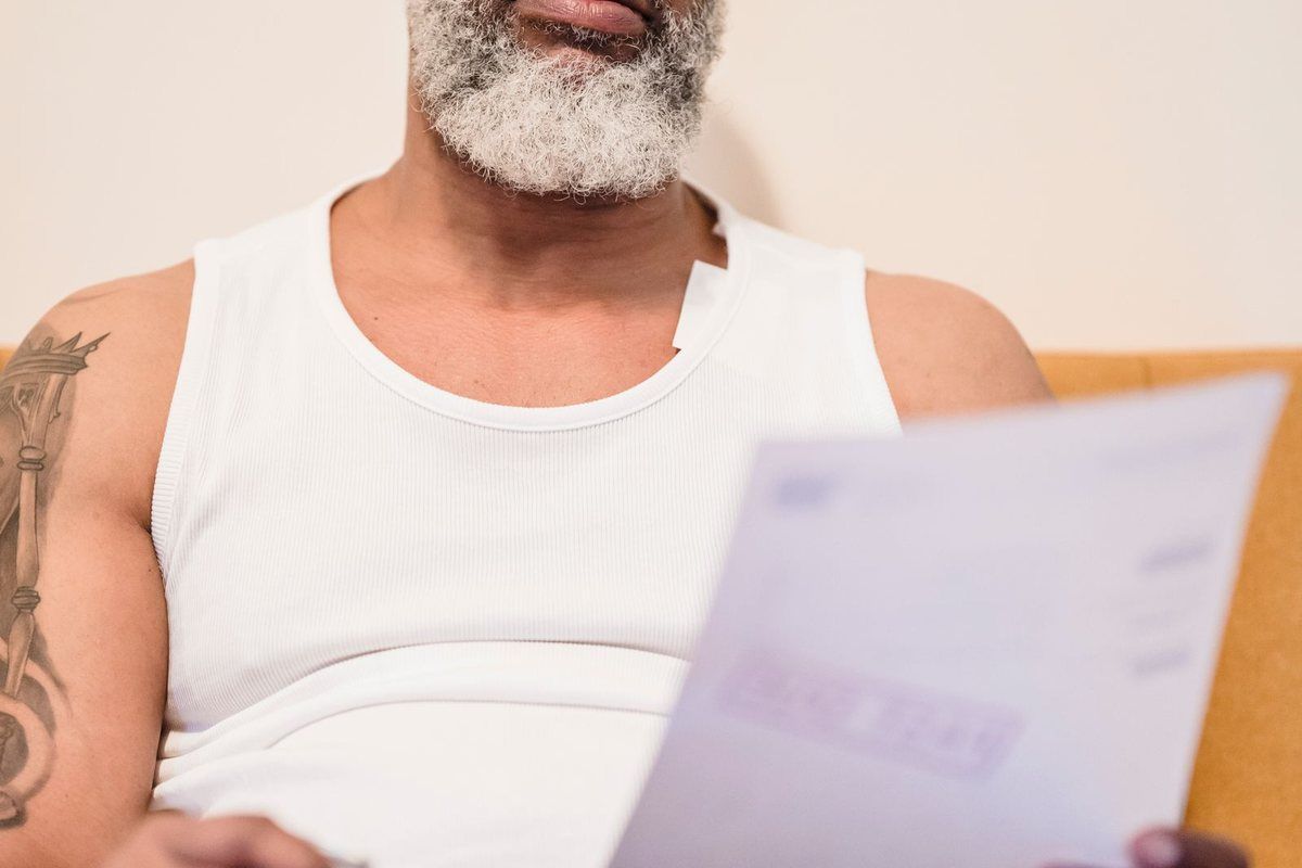 Alternatives to Chapter 7 — older man reading a document on the sofa