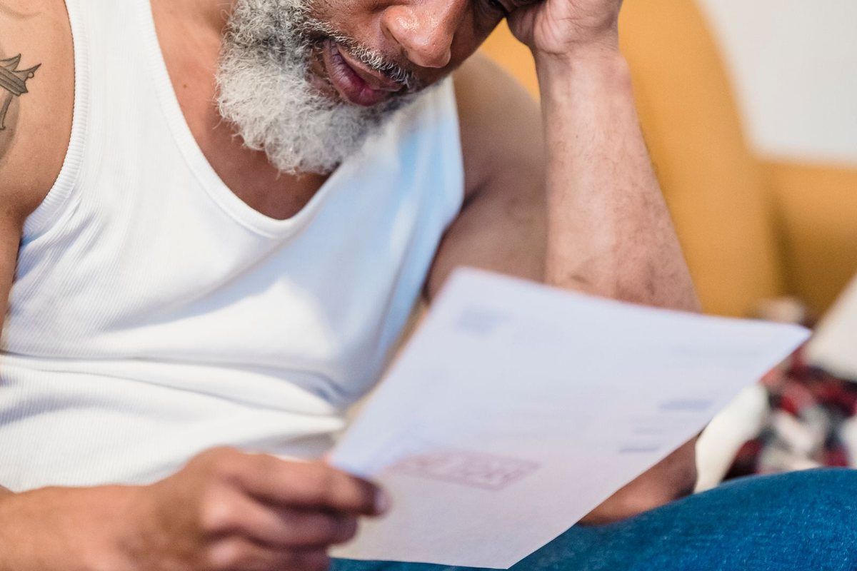 Debt Relief Instead of Bankruptcy — older man reading a letter