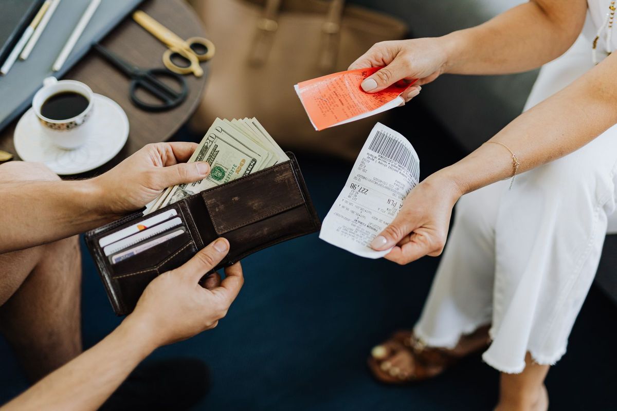 Payday Loan Relief in Charleston, WV — taking money out of a wallet