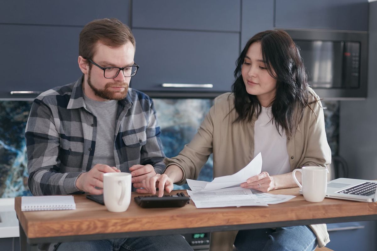 Debt consolidation loans in Huntington, WV — couple sorting bills at home