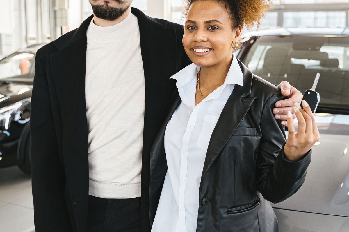 Debt Settlement Programs — couple with keys to a new vehicle