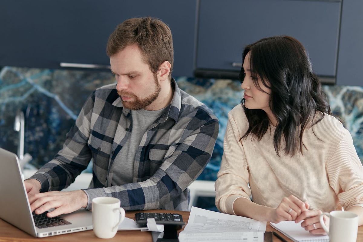 Payday Loans in Charleston, WV — couple planning a payoff on a laptop