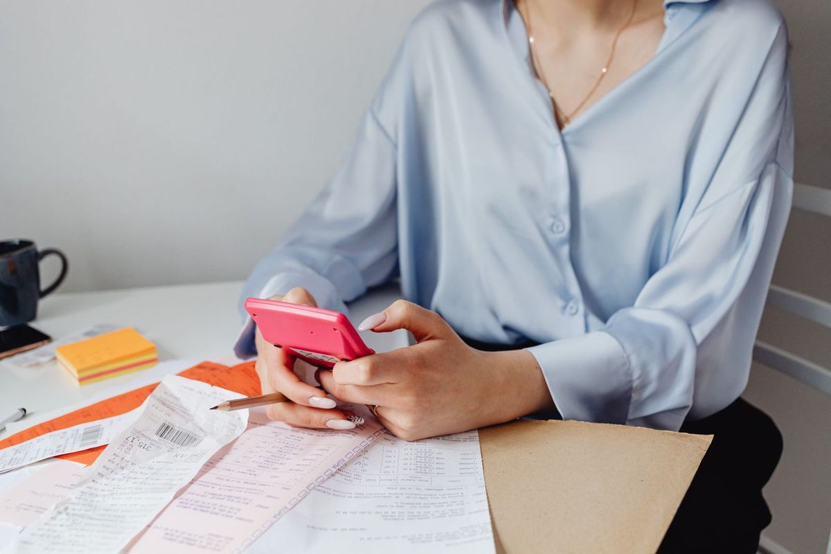 Debt consolidation loans in Parkersburg, WV — woman checking bills on her phone