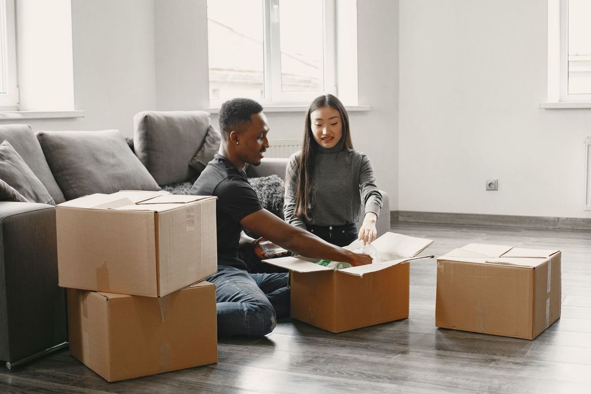How to Avoid Bankruptcy — couple unpacking moving boxes