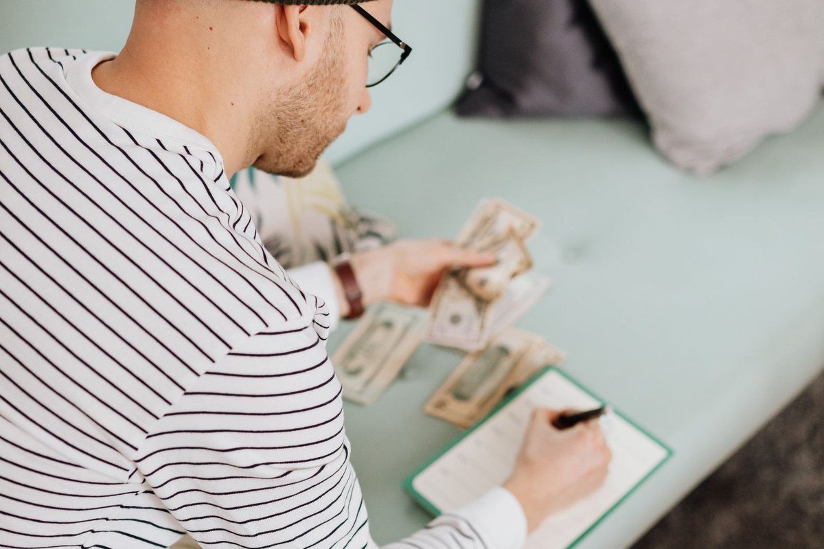 Debt Consolidation Programs — man budgeting on paper
